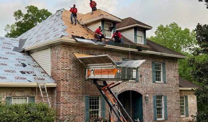 Roof Replacement in Lufkin, Texas | Southern Roofing Solutions Crew at Work Southern Roofing Solutions crew replacing residential roof in Lufkin, Texas using safety equipment and debris lift